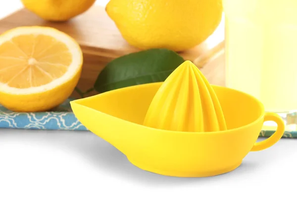 Yellow juicer and lemons — Stock Photo, Image