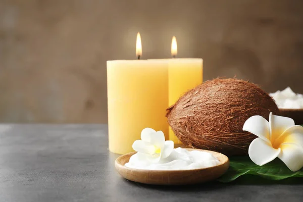 Wooden bowl with cream, coconut and candles on grey table — Stock Photo, Image