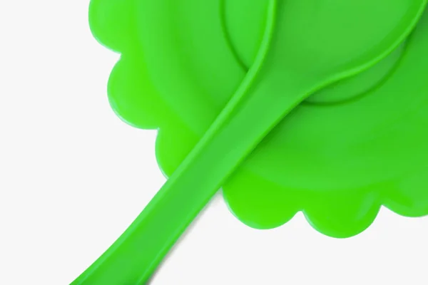 Green spoon and plate — Stock Photo, Image