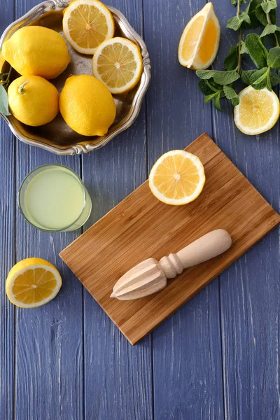 Tagliere con spremiagrumi e limoni — Foto Stock