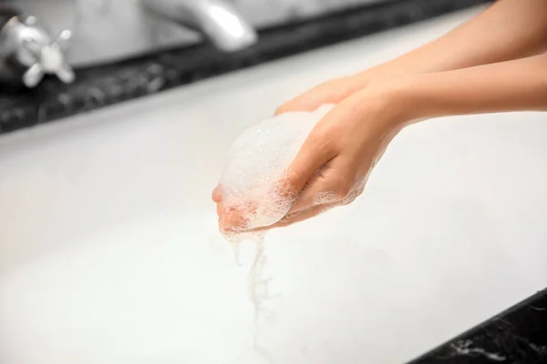 Woman with foam in hands — Stock Photo, Image