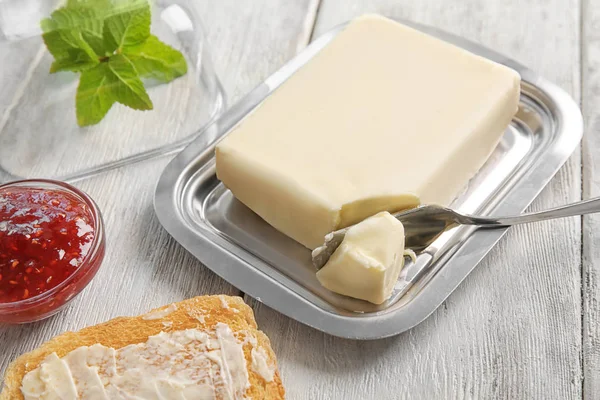 Piece of butter in dish — Stock Photo, Image