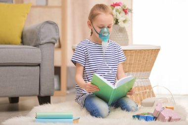 Girl using asthma machine at home clipart