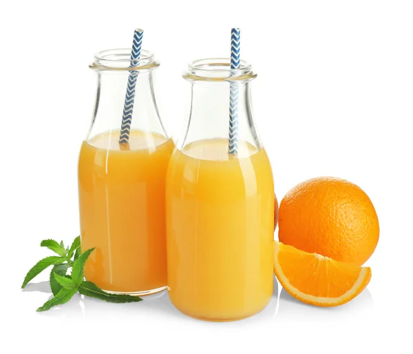 Glass bottles of fresh juice and oranges — Stock Photo, Image