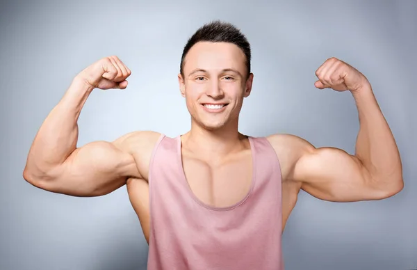 Handsome sporty man on light background — Stock Photo, Image