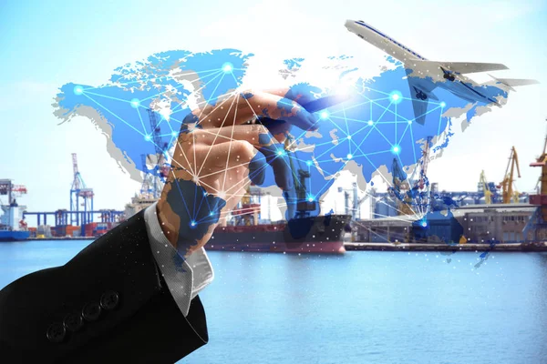 Logistic concept. Man working with virtual screen and seaport on background — Stock Photo, Image