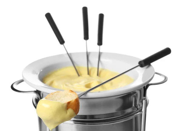 Cheese fondue in pot and piece of bread on stick against white background — Stock Photo, Image