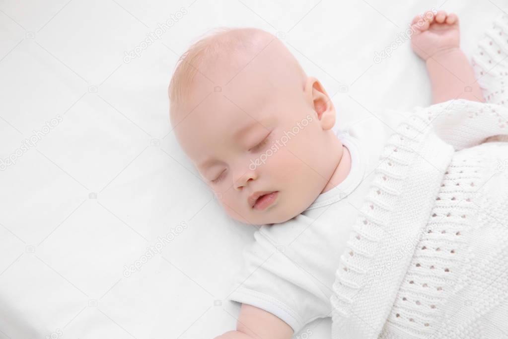 Adorable baby sleeping in cradle