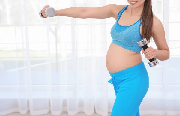 Junge schwangere Frau beim Training im Fitnessstudio. Gesundheitskonzept — Stockfoto