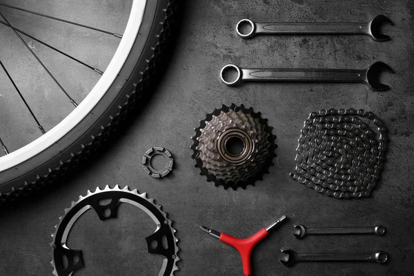 Bicycle parts and repair tools on gray background — Stock Photo, Image