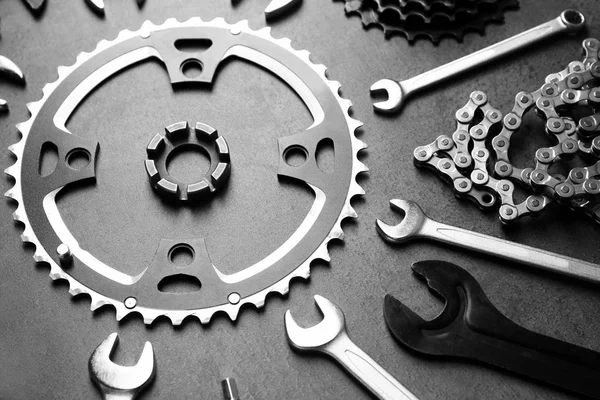 Fahrradteile und Reparaturwerkzeuge auf grauem Hintergrund — Stockfoto
