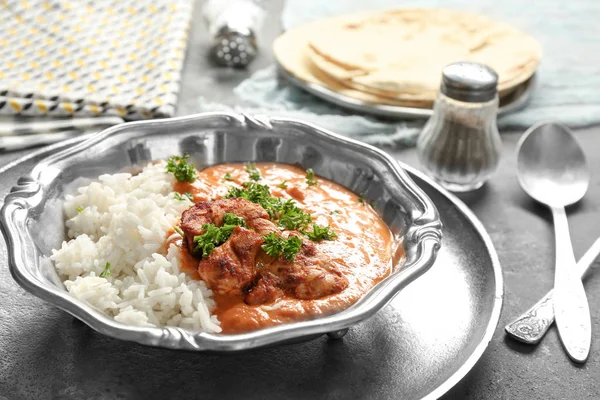 Plate with delicious Murgh Makhani and rice on table — Stock Photo, Image
