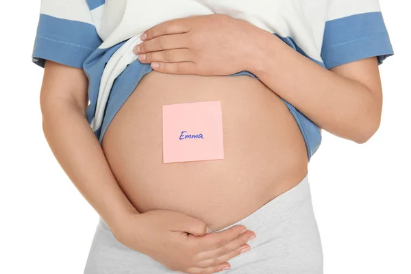 Pregnant woman with paper sticker on tummy, closeup. Concept of choosing baby name — Stock Photo, Image