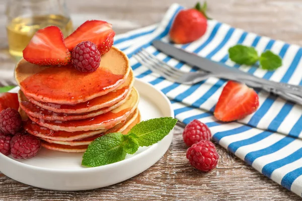 Plate with delicious pancakes on table — Stock Photo, Image