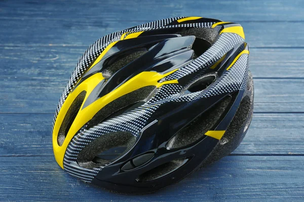 Bicycle helmet on wooden background — Stock Photo, Image