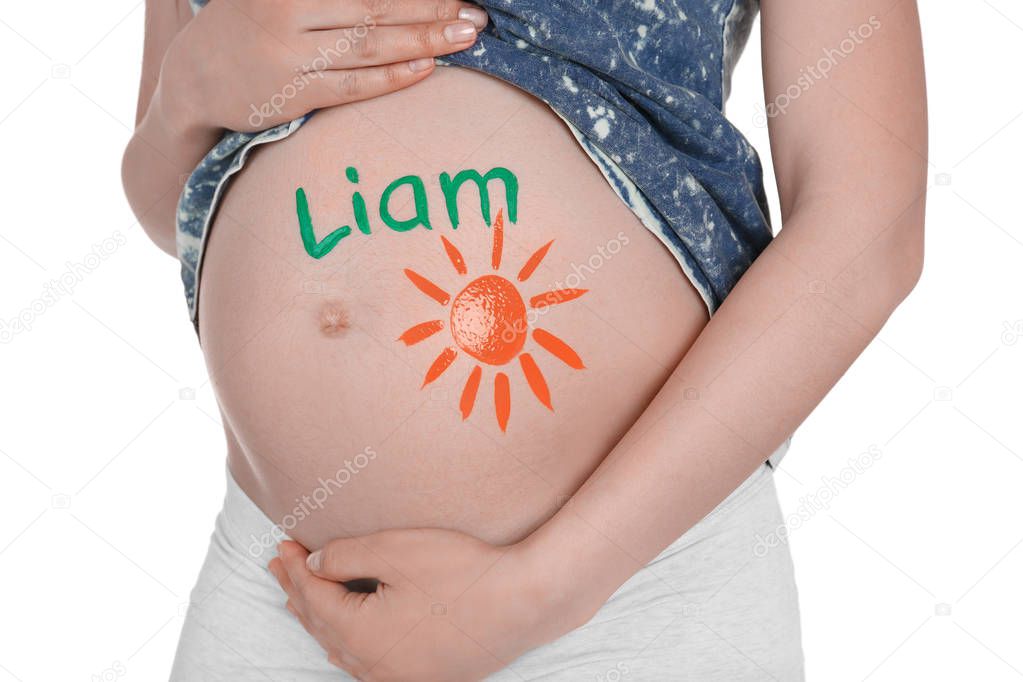 Young pregnant woman with name LIAM written on her tummy, closeup. Concept of choosing baby name