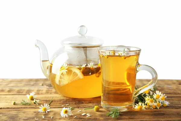 Glass teapot and cup with chamomile tea — Stock Photo, Image