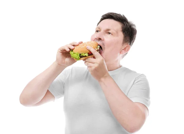 Толстяк ест бургер на белом фоне. Концепция питания — стоковое фото