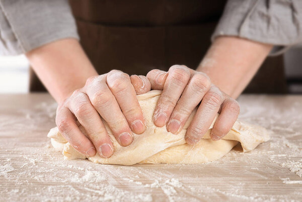 Woman kneading dough 