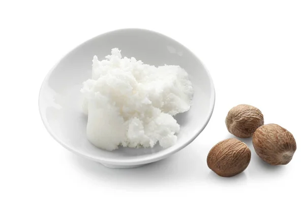 Shea butter in bowl and nuts — Stock Photo, Image