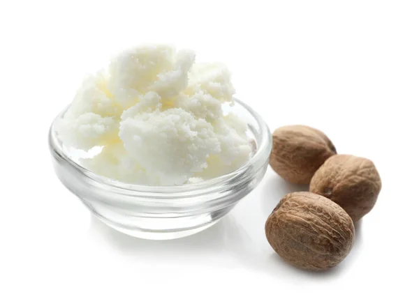 Shea butter in bowl and nuts — Stock Photo, Image
