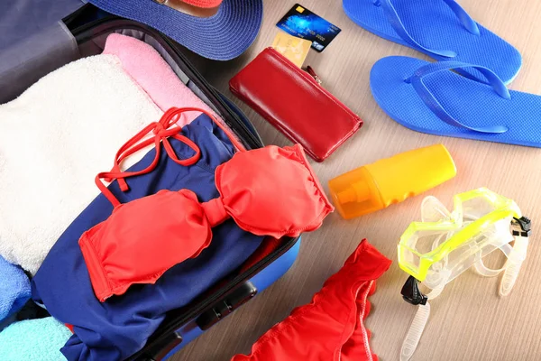 Открытый чемодан и пляжные принадлежности — стоковое фото