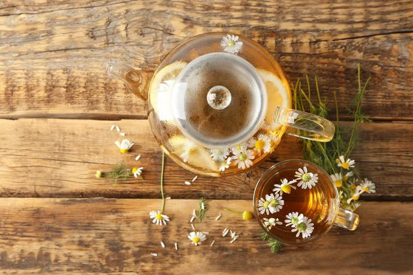 Bule de vidro e xícara com chá de camomila — Fotografia de Stock