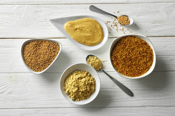 Mustard powder and sauces in dishes — Stock Photo, Image