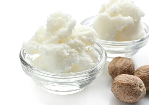 Shea butter in bowls and nuts — Stock Photo, Image