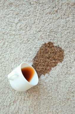 Cup of coffee spilled on carpet clipart