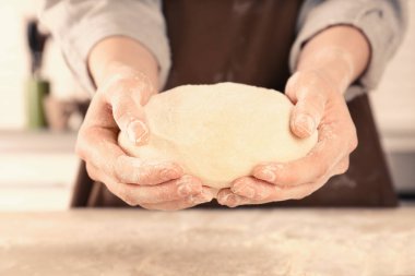 Çiğ hamur elinde tutan kadın