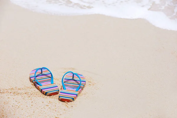 Flip-flops on beach sand — Stock Photo, Image