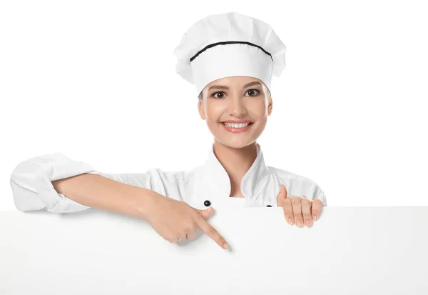 Young female chef with blank poster on white background — Stock Photo, Image