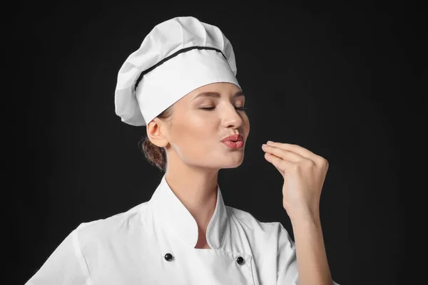 Young female chef on dark background — Stock Photo, Image