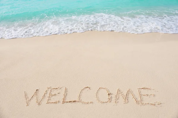 Word WELCOME on beach sand — Stock Photo, Image