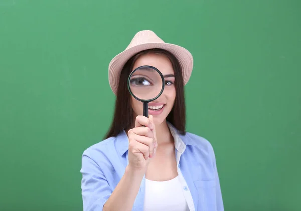 Beautiful young woman with magnifier — Stock Photo, Image