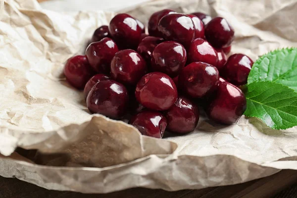 Ripe cherries on parchment paper — Stock Photo, Image