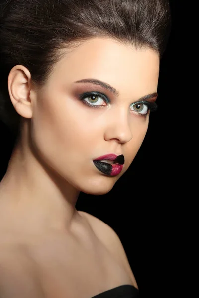 Beautiful young woman with creative makeup on dark background, closeup — Stock Photo, Image