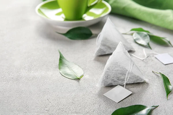 Bolsas de té y hojas en la mesa —  Fotos de Stock