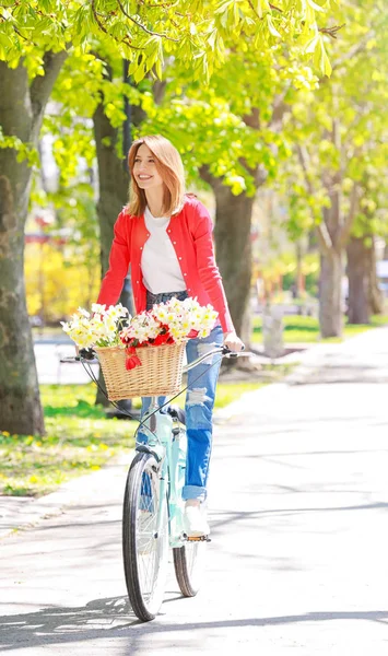 Young beautiful woman riding bicycle — Stock Photo, Image