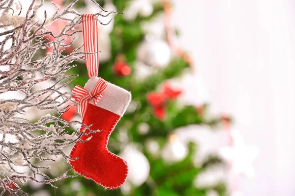 Christmas sock hanging on snowy branch — Stock Photo, Image