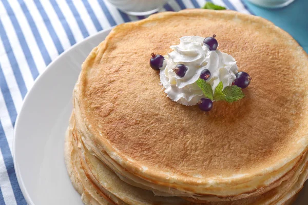 Stack of thin pancakes served with whipped cream — Stock Photo, Image