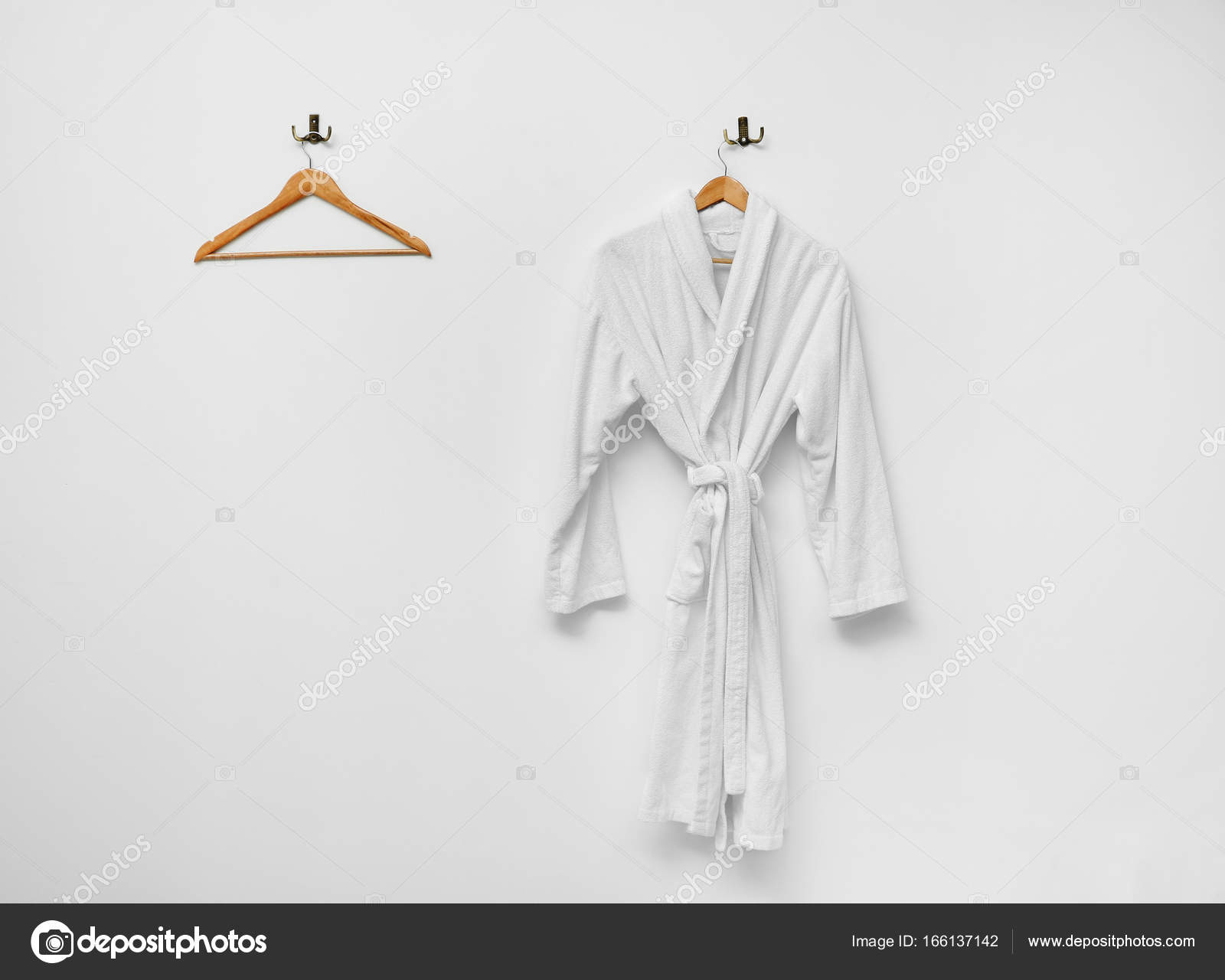 Bathrobe hanging on white wall — Stock Photo © belchonock 166137142