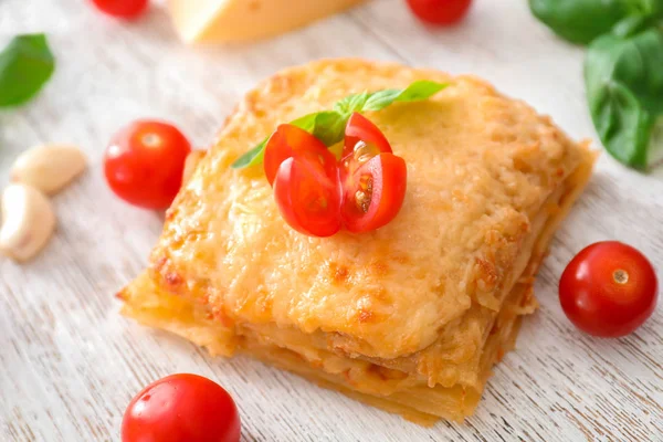 Tasty lasagna on wooden table — Stock Photo, Image