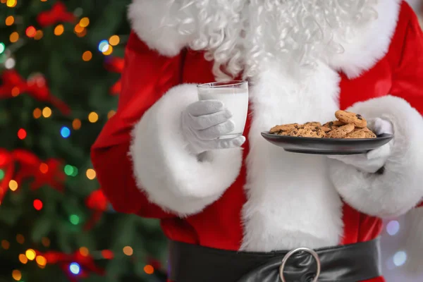 Santa Claus holding plate with cookies — Stock Photo, Image