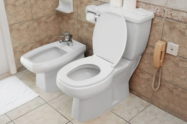 Toilet bowl and bidet in bathroom — Stock Photo, Image