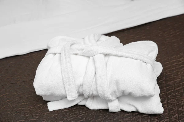 Folded bathrobes on bed — Stock Photo, Image