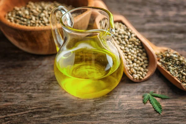 Glass pitcher with hemp oil — Stock Photo, Image