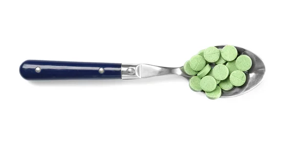 Spoon with chlorella tablets — Stock Photo, Image