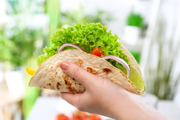 Woman holding delicious fish taco
